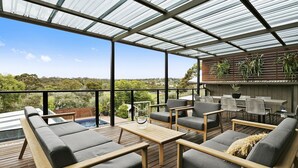 A covered outdoor area with a pool, seating, and a view of the surrounding landscape. - Pet Friendly - Miss Maude Mt Martha with pool and spa (Mount Martha)