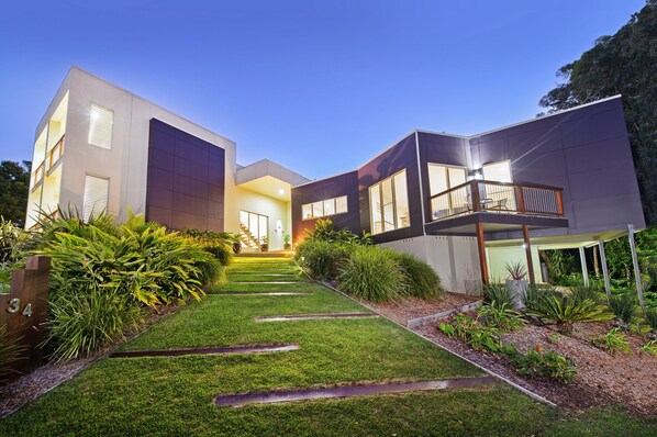 Welcome to a serene two-story residence with a beautifully maintained lawn and a balcony.