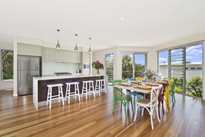 Enjoy cooking in this kitchen with a central island, bar stools, refrigerator, and microwave.