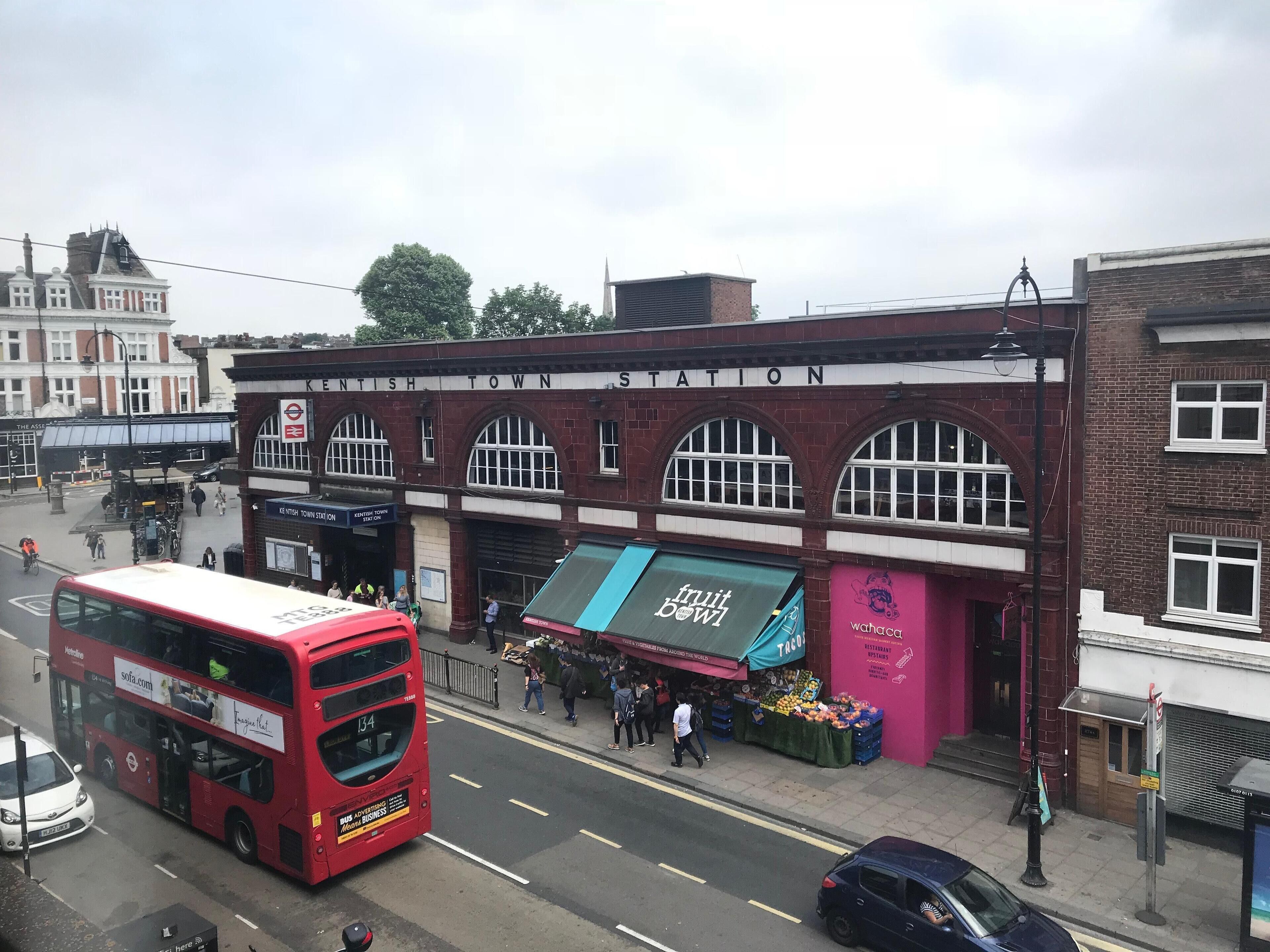 A red double-decker bus at Kentish Town Station.