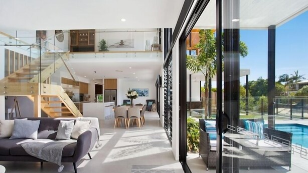 A modern interior with a living area, dining space, and a view of a swimming pool. - Relax, Chill, Enjoy and Luxury all comes in this Property! (Gold Coast)