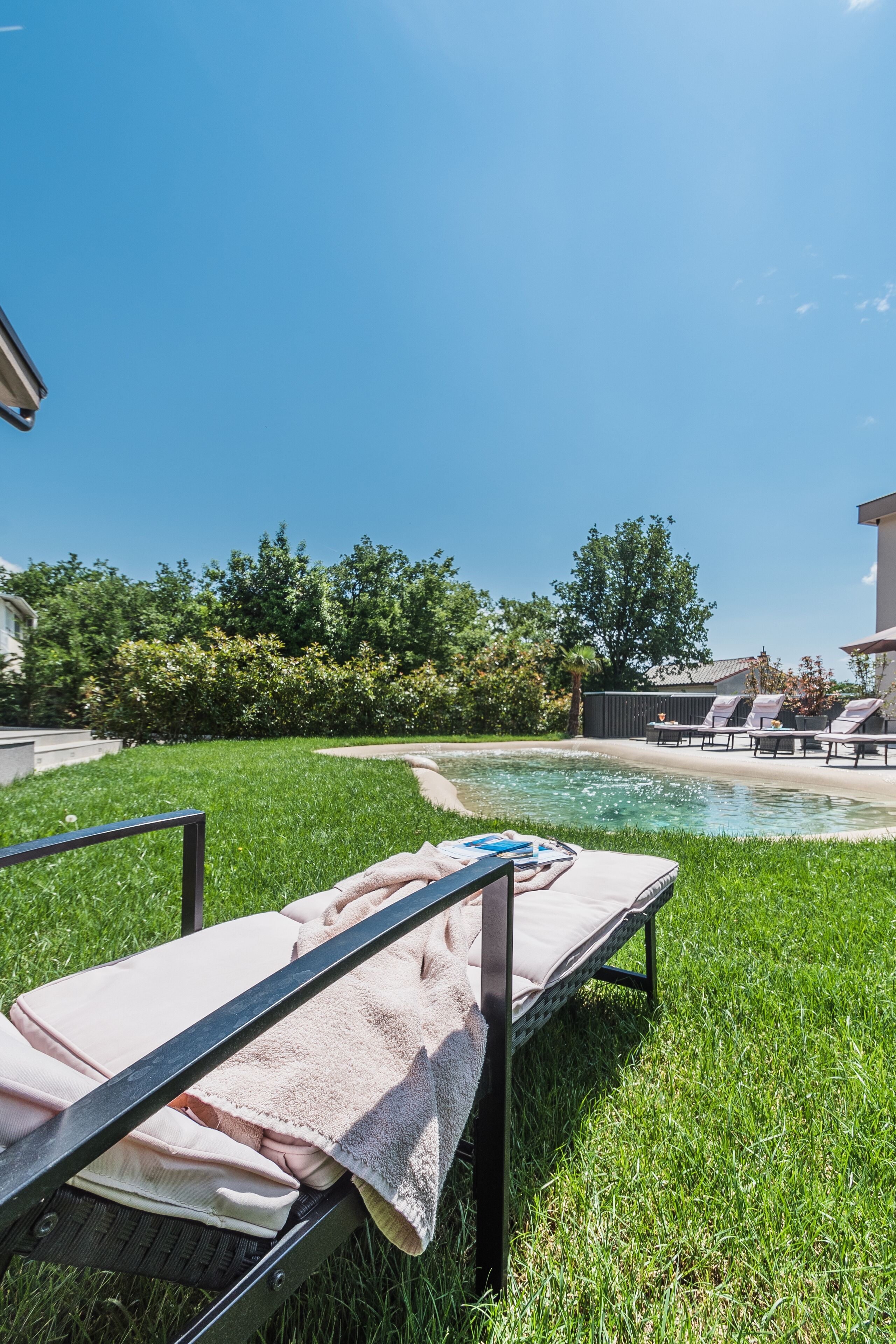 A poolside area with lounge chairs and a towel.