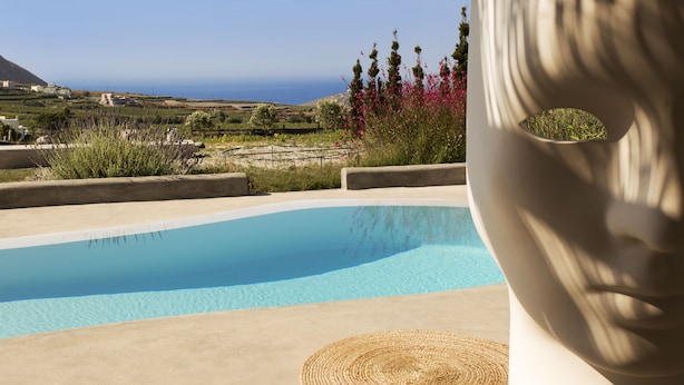 A pool with a clear view of the ocean and hills in the background. - Kota Villa with private pool (Santorini)