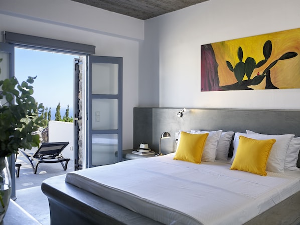 A modern bedroom with a large bed, a nightstand, a lamp, and a painting on the wall.