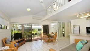 A spacious living area with a balcony, a dining set, and a sofa. - Driftwood Mantaray Three Bedroom Loft (Douglas)
