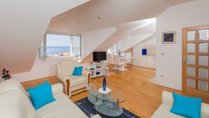 A spacious living area with a large window, a dining table, and a kitchen area. - Apartment  Bellissima vista (Dubrovnik)