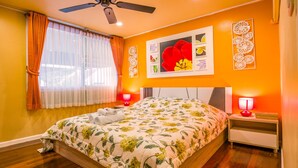 A bedroom with a floral bedspread, a ceiling fan, and two bedside lamps. - VERY PEACEFUL "EDEN GATE VILLA" CENTRAL CHIANG MAI (Chiang mai)