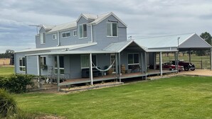 A two-story house with a covered porch and a carport. - Jackaleah Farm  Stay Oxley (Oxley)