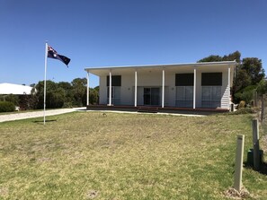 A modern two-story building with a covered porch and a flagpole. - Relax at "Kangaroo Pause" @ Clayton Bay (Clayton Bay)