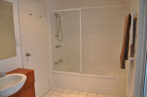 A bathroom with a glass-enclosed shower, a white sink, and a towel rack. - Relax at "Kangaroo Pause" @ Clayton Bay (Clayton Bay)