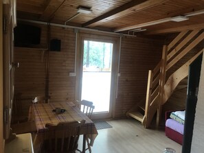 Enjoy a rustic retreat with a dining area near a window offering a view of the outdoors.