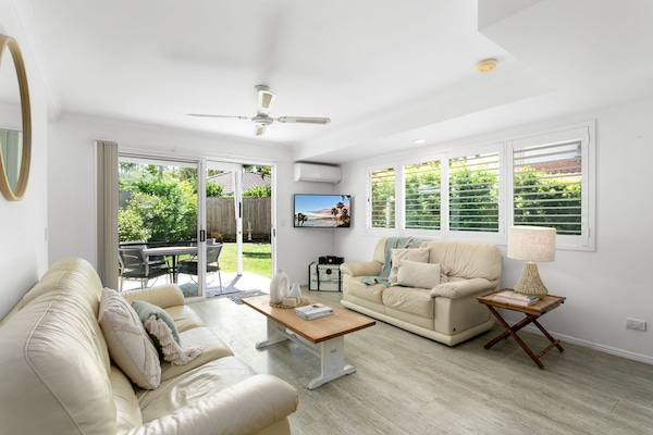 spacious living area leading to fully fenced backyard and garden.