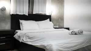 A neatly made bed with white linens and two rolled towels on the side. - Perfect location  with panoramic sea view facing Gordon Beach (Tel Aviv-Yafo)