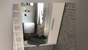 A bathroom with a white sink, a mirror, and a towel rack. - Cozy apartment for 4 (Marina)