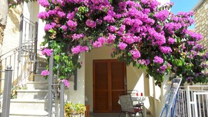 A balcony with a table and chairs, a wooden door, and a metal railing. - in a quiet position,close to sea 1 (ZADAR)