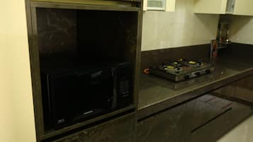 Fridge, microwave, cookware/dishes/utensils, dining tables
