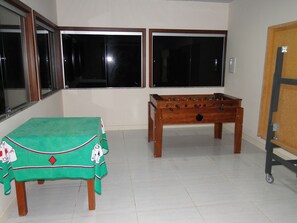 Enjoy a game night in with a card table and foosball table.