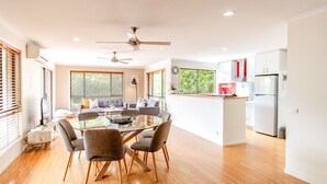 A modern kitchen with white cabinets, a built-in oven, and a refrigerator.