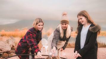 Three people around a campfire.