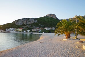 On the beach, sun-loungers