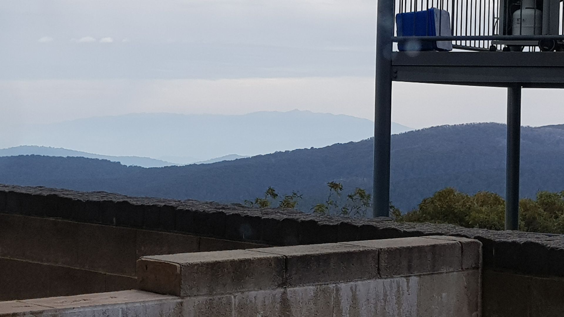 A view from a balcony overlooking a mountainous landscape.
