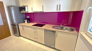 A modern kitchen with white cabinets, a stainless steel sink, a microwave, and a dishwasher. - Heated swimming pool, spacious apartment with bay sea view terrace  ap3 (Okrug Gornji)