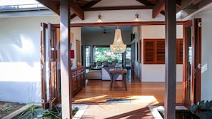 A spacious interior with a wooden floor, a dining area, and a view of the outdoors.