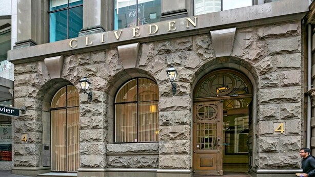 A stone building with the name 'CLIVEDEN' above the entrance. There are three arched windows and a door with a sign above it. - Sydney- CLD01 Bridge Street - Modern 1BR with Rooftop Pool in the Heart of Sydney CBD (Sydney)
