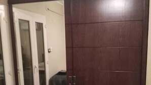 A bedroom with a large sliding door closet, a bed with a blue cover, and a carpeted floor. - in the center of Cairo (Cairo)