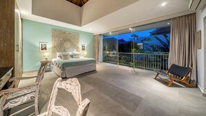 A spacious bedroom with a large bed, a balcony with a view, and a dining area with chairs. - Villa Jekumah 3 - 1 minute walk to restaurants (Kerobokan)