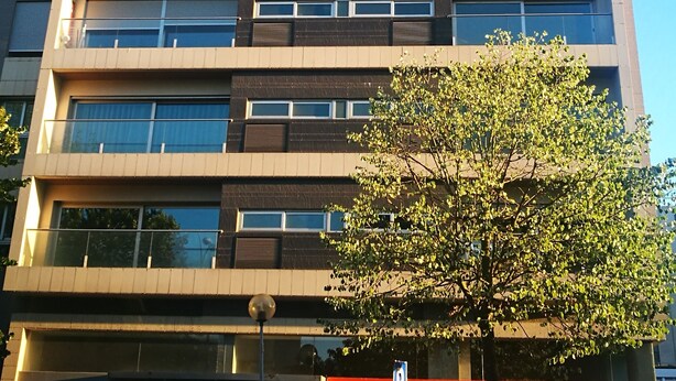 A multi-story building with a modern architectural design, featuring a prominent 'bankinter' sign at the ground level.