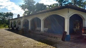 A building with a series of arches and a covered walkway. - Nature and Welfare (Sete Barras)