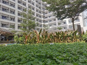 Experience the seamless blend of architecture and nature at this contemporary building, featuring a lush garden and balconies.