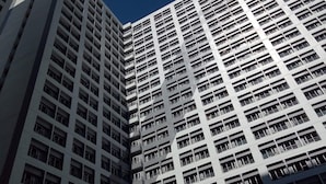 A high-rise building with a grid of balconies and windows.