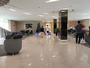 Relax in a spacious lobby with comfortable seating areas and a clean, minimalist design.