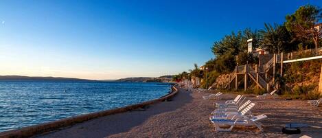 On the beach, sun-loungers