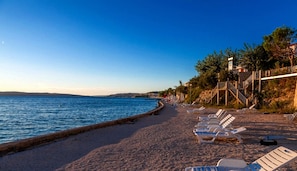 On the beach, sun-loungers