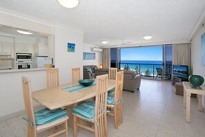 Relax in this stylish living area with a dining table for four, comfortable sofa, and flat-screen TV, plus a balcony with ocean views.