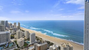 A coastal cityscape with high-rise buildings, a beach, and the ocean. - Apartment 22502. Located high on the 25th floor of this famous resort hotel (Surfers Paradise)