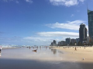 Guests can enjoy a serene beach experience with stunning views of the city skyline.