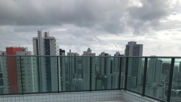 A rooftop swimming pool with tiled walls and a glass railing. - studio golden breeze 1101 (recife)