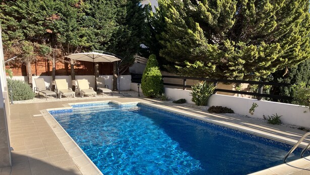 A rectangular swimming pool with clear blue water, surrounded by a tiled deck. - Private Pool - All En-Suite - Games Room - Large Sun Terrace - Full A/C - WiFi (Pissouri)