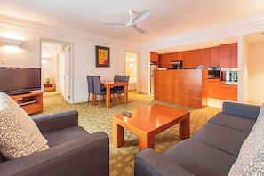 Deluxe Apartment, 2 Bedrooms | Living room | 32-inch TV with cable channels