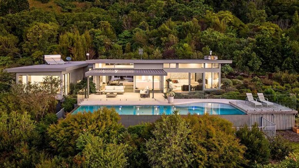A modern two-story house with a large swimming pool, surrounded by lush greenery. - The Springs - architect-designed home with pool (Wilsons Creek)