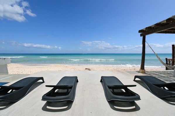 On the beach, sun loungers, beach towels