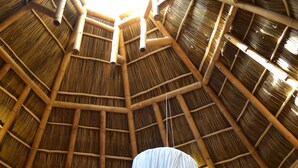 A room with a high thatched roof, a bed with a canopy, and wooden doors. - Mint Cabin 1. Romantic Ecolodge in the jungle by the sea (San Pancho)