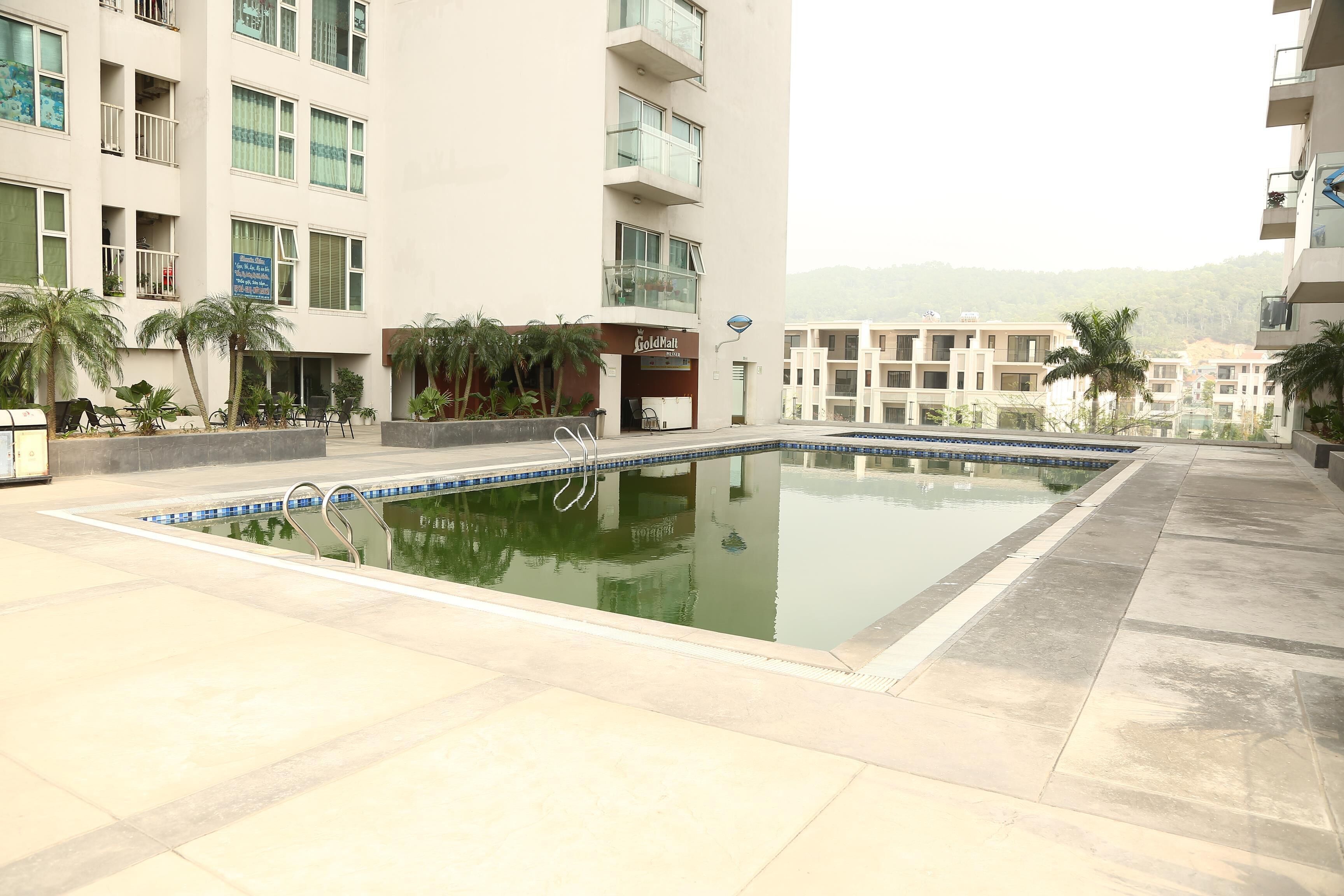 A swimming pool with a clear blue edge, surrounded by a tiled deck.