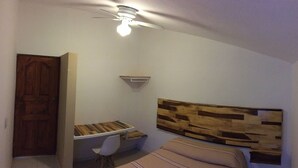 A bedroom with a wooden headboard, a desk with a chair, and a ceiling fan. - Perfect place for rest. Near to Oaxaca (Oaxaca)