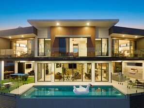A modern two-story house with a swimming pool and a swan float. - CENTRAL LOCATION FOR LUXURY VACATION (Gold Coast)