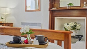 A neatly arranged breakfast tray with a cup, a pitcher, and a vase with flowers on a bed. - CygnetOldBank- Accommodation, Cafe Escape the everyday, style & bliss (Cygnet)